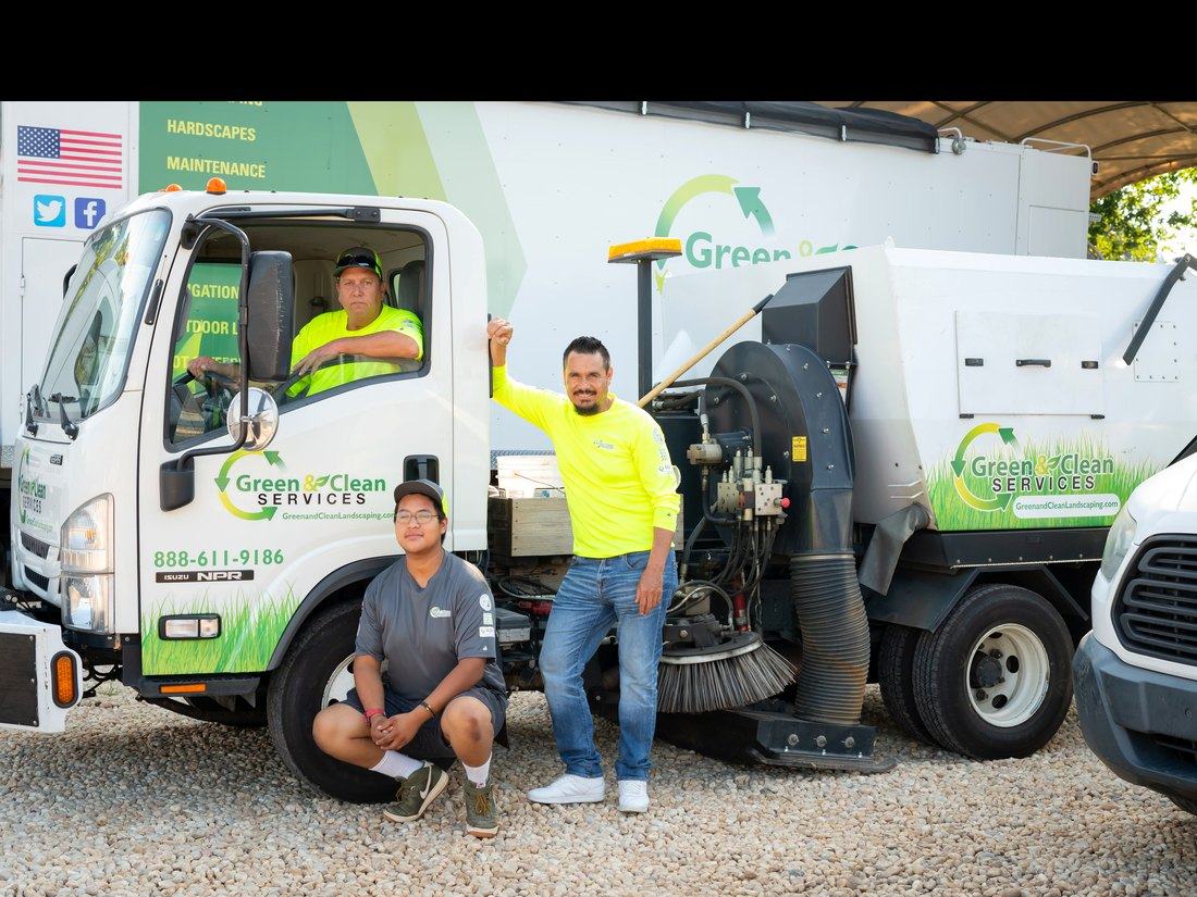 Rise & Shine sweeping crew and truck on a commercial job site